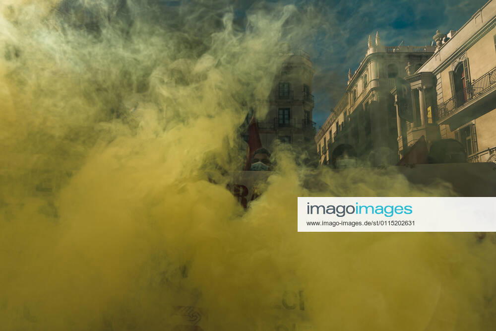 Catalan doctors shout slogans amid colored smoke as they protest for a 100% public health care system, equal pay, labor protection, early retirement, and a reduction of weekly, hours among other demands, during a strike in the Catalan public health care system Barcelona Spain - ZUMAo105 20210310_zap_o105_005