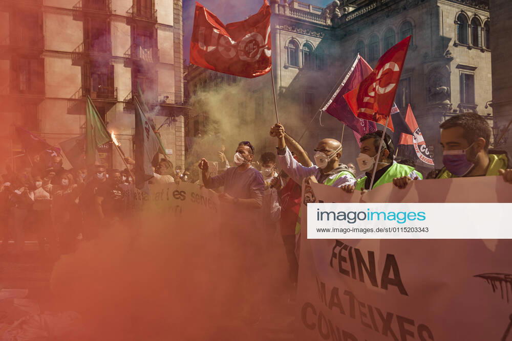Catalan doctors shout slogans amid colored smoke as they protest for a 100% public health care system, equal pay, labor protection, early retirement, and a reduction of weekly, hours among other demands, during a strike in the Catalan public health care system Barcelona Spain - ZUMAo105 20210310_zap_o105_028