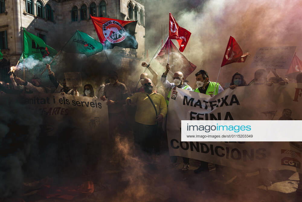 Catalan doctors shout slogans amid colored smoke as they protest for a 100% public health care system, equal pay, labor protection, early retirement, and a reduction of weekly, hours among other demands, during a strike in the Catalan public health care system Barcelona Spain - ZUMAo105 20210310_zap_o105_029