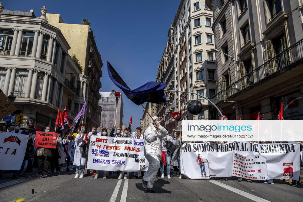 Protesters marching with huge banner at Via Laietana during the demonstration..Under the slogan estemfartes (we are fed up), the Catalan Health Union Board, formed by minority unions, has mobilized health workers to a day of strike to denounce the physical fatigue of health professionals and salary cuts. Barcelona Spain - ZUMAs197 20210310_zaa_s197_154