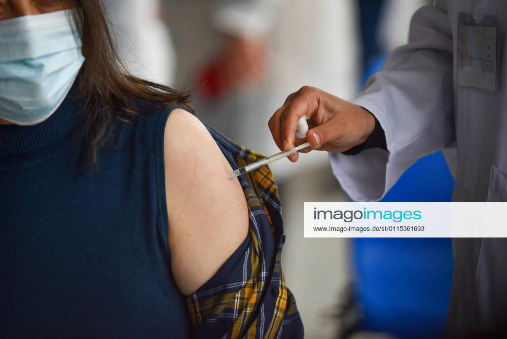 A health worker administers the Sputnik V COVID-19 vaccine to a front liner at Menzah Regional Center..The Tunisian government says that the aim of this session is to reach 50% of the country s population to vaccinate. The vaccine which is currently being distributed to various stations across the country will first be administered to healthcare workers, teachers and people whose immunity is compromised. Tunis Tunisia - ZUMAs197 20210313_zaa_s197_021