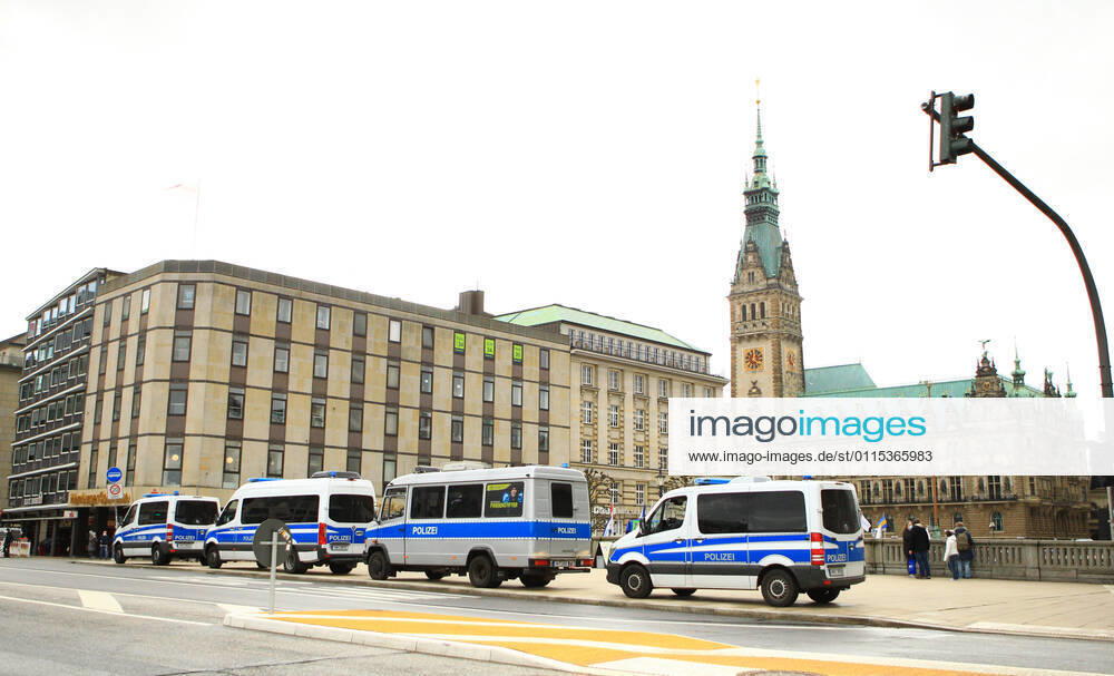 Police patrol cars are parked at the Reesendamm Bridge on Hamburgs Jungfernstieg In the background, Hamburgs City Hall Police forces prepare for a demonstration by critics of the federal governments Corona policy, which will take place on the Rathausplatz Downtown Hamburg