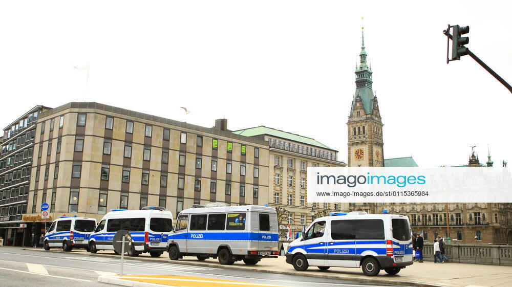 Police patrol cars are parked at the Reesendamm Bridge on Hamburgs Jungfernstieg In the background, Hamburgs City Hall Police forces prepare for a demonstration by critics of the federal governments Corona policy, which will take place on the Rathausplatz Downtown Hamburg
