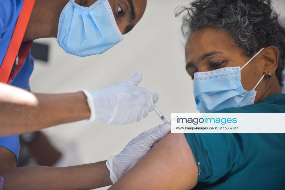 (210313) -- ADDIS ABABA, March 13, 2021 -- A medical worker administers the COVID-19 vaccine to a recipient in Addis Ababa, Ethiopia, on March 13, 2021. Ethiopian State Minister of Health Dereje Duguma disclosed on Saturday that the east African country plans to give COVID-19 vaccine jabs to 20 percent of its population by March 2022. Duguma disclosed the plan during a ceremony in Addis Ababa to officially start COVID-19 vaccine jabs in the country. ) ETHIOPIA-ADDIS ABABA-COVID-19 VACCINATION-START MichaelxTewelde