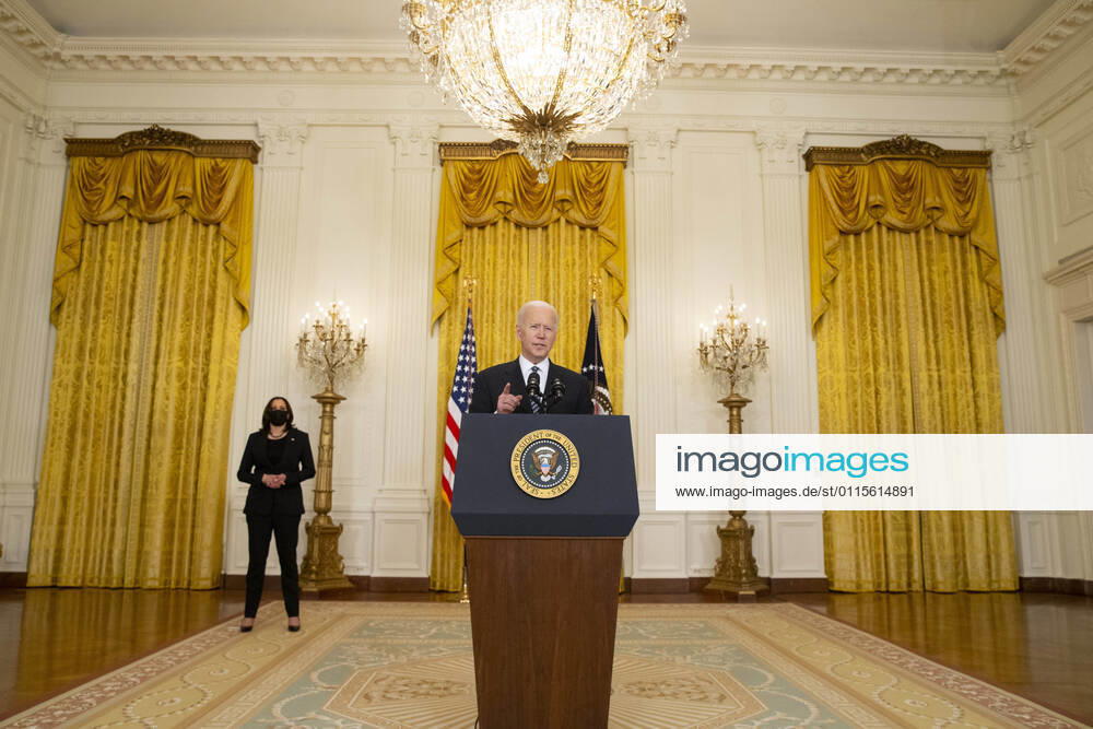 US President Joe Biden delivers remarks on the state of COVID-19 vaccinations, as US Vice President Kamala Harris (Back) looks on in the East Room of the White House in Washington, DC, USA, 18 March 2021. The United States has surpassed 100 million COVID-19 vaccine doses administered Washington USA - ZUMAs152 20210318_zaa_s152_226