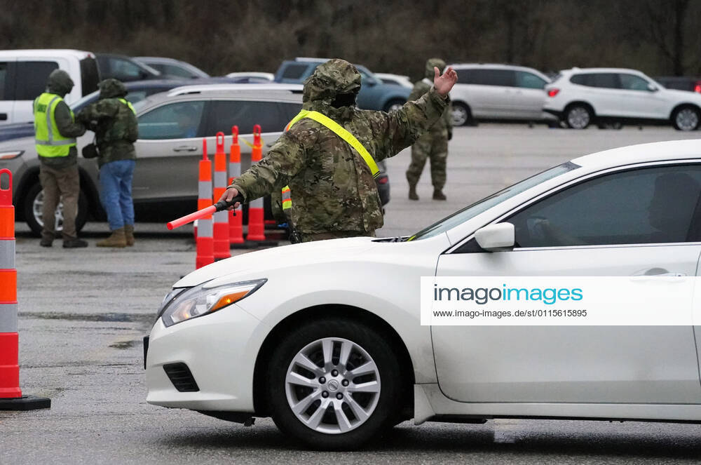 Missouri National Guardsmen direct traffic as cars line up for vaccination shots at the Family Arena during a mass vaccination drive-in event in St. Charles, Missouri on Thursday, March 18, 2021. The event attracted 4,000 people, some waiting over four hours in their cars for their first shot to protect them from the coronavirus. SLP2021031813 BILLxGREENBLATT