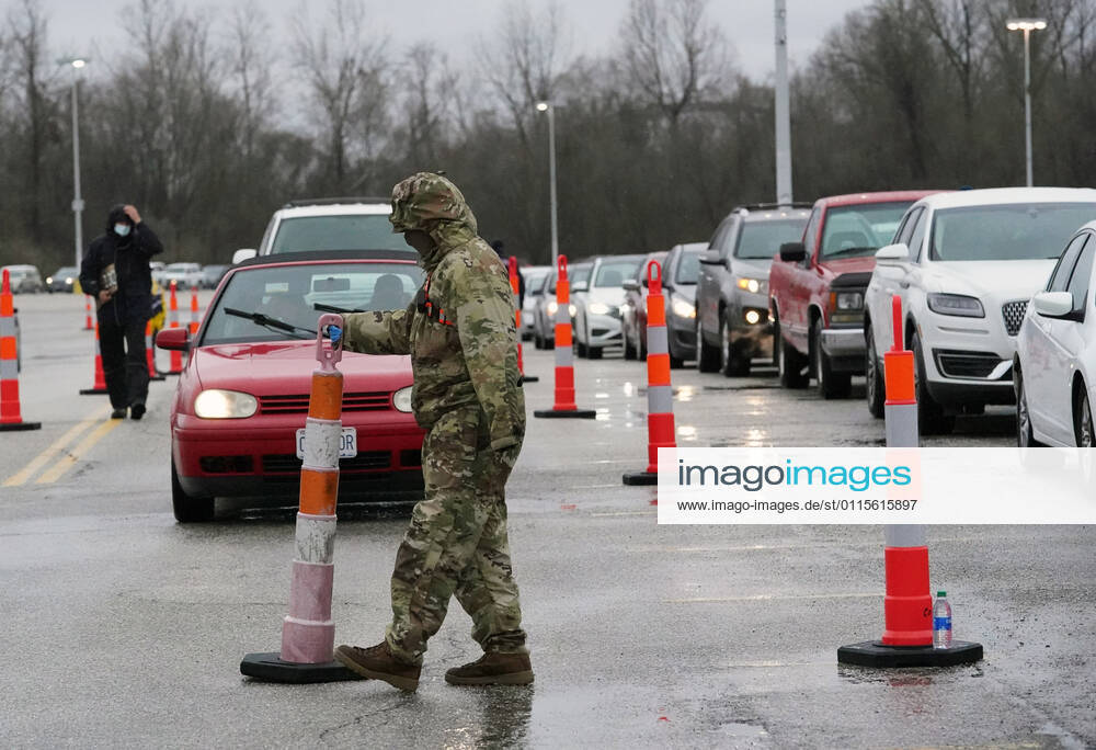 Missouri National Guardsmen direct traffic as cars line up for vaccination shots at the Family Arena during a mass vaccination drive-in event in St. Charles, Missouri on Thursday, March 18, 2021. The event attracted 4,000 people, some waiting over four hours in their cars for their first shot to protect them from the coronavirus. SLP2021031814 BILLxGREENBLATT