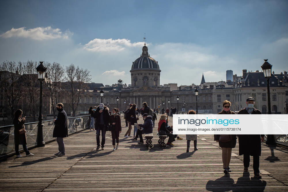 (210320) -- PARIS, March 20, 2021 -- People walk on the Pont des Arts bridge in Paris, France, on March 20, 2021. French Prime Minister Jean Castex on Thursday announced new massive measures to curb COVID-19 in the country s 16 worst-hit regions, including Paris. Starting Friday midnight, about 18 million French people in regions such as Paris, Hauts-de-France in the north as well as the Alpes-Maritimes on the Mediterranean should stay at home, Castex announced at a press briefing on the epidemic situation. (Photo by Xinhua) FRANCE-PARIS-COVID-19-PARTIAL LOCKDOWN AurelienxMorissard