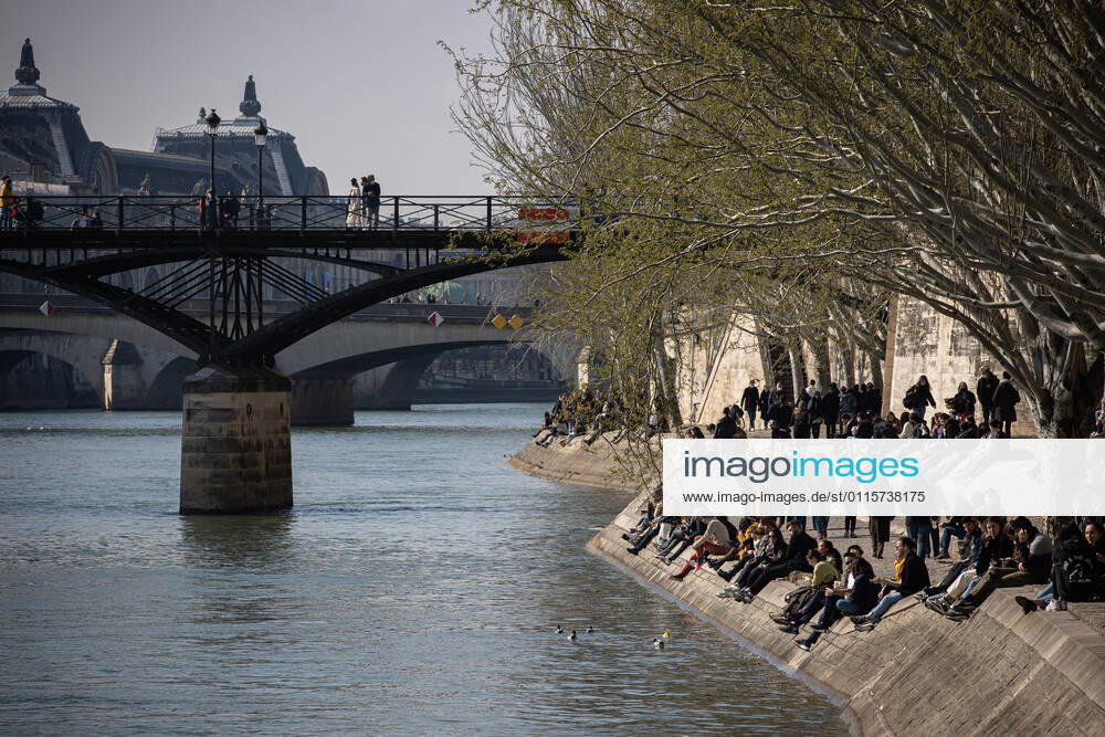 (210320) -- PARIS, March 20, 2021 -- People enjoy sunshine at the bank of Seine in Paris, France, on March 20, 2021. French Prime Minister Jean Castex on Thursday announced new massive measures to curb COVID-19 in the country s 16 worst-hit regions, including Paris. Starting Friday midnight, about 18 million French people in regions such as Paris, Hauts-de-France in the north as well as the Alpes-Maritimes on the Mediterranean should stay at home, Castex announced at a press briefing on the epidemic situation. (Photo by Xinhua) FRANCE-PARIS-COVID-19-PARTIAL LOCKDOWN AurelienxMorissard