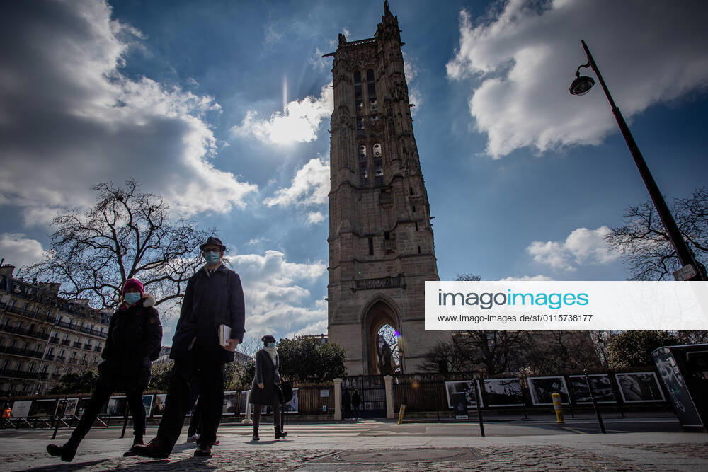 (210320) -- PARIS, March 20, 2021 -- People with face masks walk on a street in Paris, France, on March 20, 2021. French Prime Minister Jean Castex on Thursday announced new massive measures to curb COVID-19 in the country s 16 worst-hit regions, including Paris. Starting Friday midnight, about 18 million French people in regions such as Paris, Hauts-de-France in the north as well as the Alpes-Maritimes on the Mediterranean should stay at home, Castex announced at a press briefing on the epidemic situation. (Photo by Xinhua) FRANCE-PARIS-COVID-19-PARTIAL LOCKDOWN AurelienxMorissard