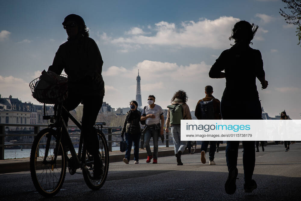 (210320) -- PARIS, March 20, 2021 -- People walk along the bank of Seine in Paris, France, on March 20, 2021. French Prime Minister Jean Castex on Thursday announced new massive measures to curb COVID-19 in the country s 16 worst-hit regions, including Paris. Starting Friday midnight, about 18 million French people in regions such as Paris, Hauts-de-France in the north as well as the Alpes-Maritimes on the Mediterranean should stay at home, Castex announced at a press briefing on the epidemic situation. (Photo by Xinhua) FRANCE-PARIS-COVID-19-PARTIAL LOCKDOWN AurelienxMorissard