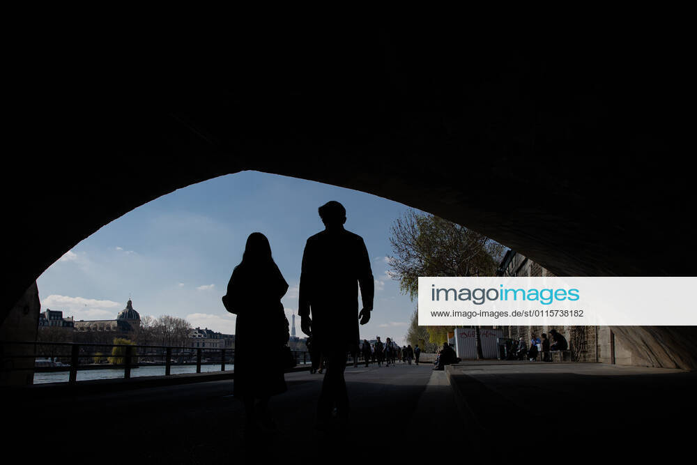 (210320) -- PARIS, March 20, 2021 -- People walk along the bank of Seine in Paris, France, on March 20, 2021. French Prime Minister Jean Castex on Thursday announced new massive measures to curb COVID-19 in the country s 16 worst-hit regions, including Paris. Starting Friday midnight, about 18 million French people in regions such as Paris, Hauts-de-France in the north as well as the Alpes-Maritimes on the Mediterranean should stay at home, Castex announced at a press briefing on the epidemic situation. (Photo by Xinhua) FRANCE-PARIS-COVID-19-PARTIAL LOCKDOWN AurelienxMorissard