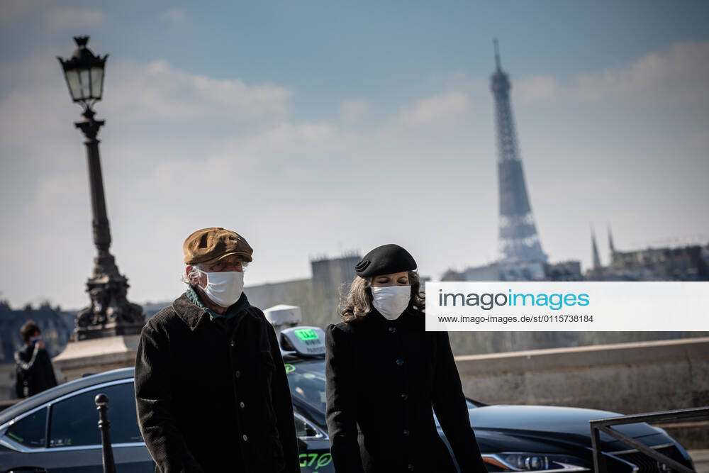 (210320) -- PARIS, March 20, 2021 -- People with face masks walk on a street in Paris, France, on March 20, 2021. French Prime Minister Jean Castex on Thursday announced new massive measures to curb COVID-19 in the country s 16 worst-hit regions, including Paris. Starting Friday midnight, about 18 million French people in regions such as Paris, Hauts-de-France in the north as well as the Alpes-Maritimes on the Mediterranean should stay at home, Castex announced at a press briefing on the epidemic situation. (Photo by Xinhua) FRANCE-PARIS-COVID-19-PARTIAL LOCKDOWN AurelienxMorissard