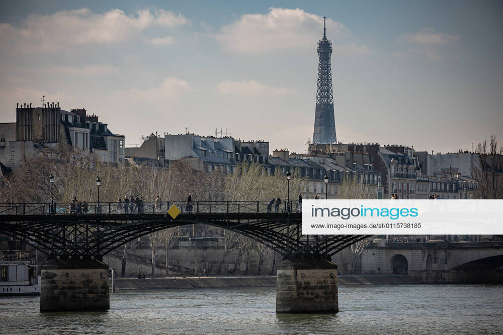 (210320) -- PARIS, March 20, 2021 -- People walk on the Pont des Arts bridge in Paris, France, on March 20, 2021. French Prime Minister Jean Castex on Thursday announced new massive measures to curb COVID-19 in the country s 16 worst-hit regions, including Paris. Starting Friday midnight, about 18 million French people in regions such as Paris, Hauts-de-France in the north as well as the Alpes-Maritimes on the Mediterranean should stay at home, Castex announced at a press briefing on the epidemic situation. (Photo by Xinhua) FRANCE-PARIS-COVID-19-PARTIAL LOCKDOWN AurelienxMorissard