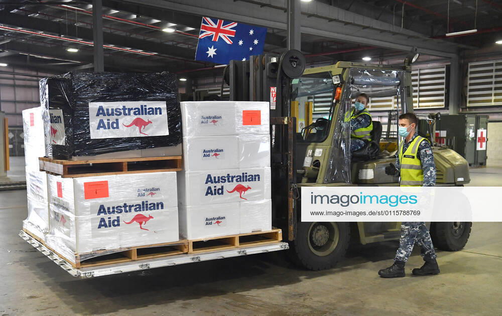 AUSMAT VACCINE PNG COVID19 RESPONSE, Royal Australian Air Force personal are seen preparing COVID-19 vaccines and humanitarian supplies for loading onto a C-17A Globemaster at RAAF Base Amberley, west of Brisbane, Tuesday, March 23, 2021. Australia are sending 8,000 doses of its COVID-19 vaccine supply to Papua New Guinea who have more than 1,400 active cases of COVID-19 and the Australian government are asking AstraZeneca and European authorities to divert another 1 million doses to Papua New Guinea. ( NO ARCHIVING, , NO USE IN BOOKS WITHOUT CONSENT BRISBANE QLD AUSTRALIA