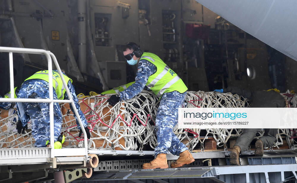 AUSMAT VACCINE PNG COVID19 RESPONSE, Royal Australian Air Force personal are seen loading COVID-19 vaccines and humanitarian supplies onto a C-17A Globemaster at RAAF Base Amberley, west of Brisbane, Tuesday, March 23, 2021. Australia are sending 8,000 doses of its COVID-19 vaccine supply to Papua New Guinea who have more than 1,400 active cases of COVID-19 and the Australian government are asking AstraZeneca and European authorities to divert another 1 million doses to Papua New Guinea. ( NO ARCHIVING, , NO USE IN BOOKS WITHOUT CONSENT BRISBANE QLD AUSTRALIA