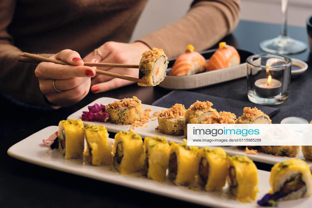Young customer eating sushi with chopsticks at restaurant model released Symbolfoto property released AODF00304