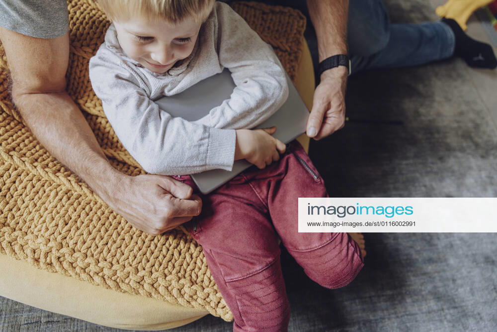 Father struggling while taking digital tablet from displeased boy model released Symbolfoto property released MFF07173