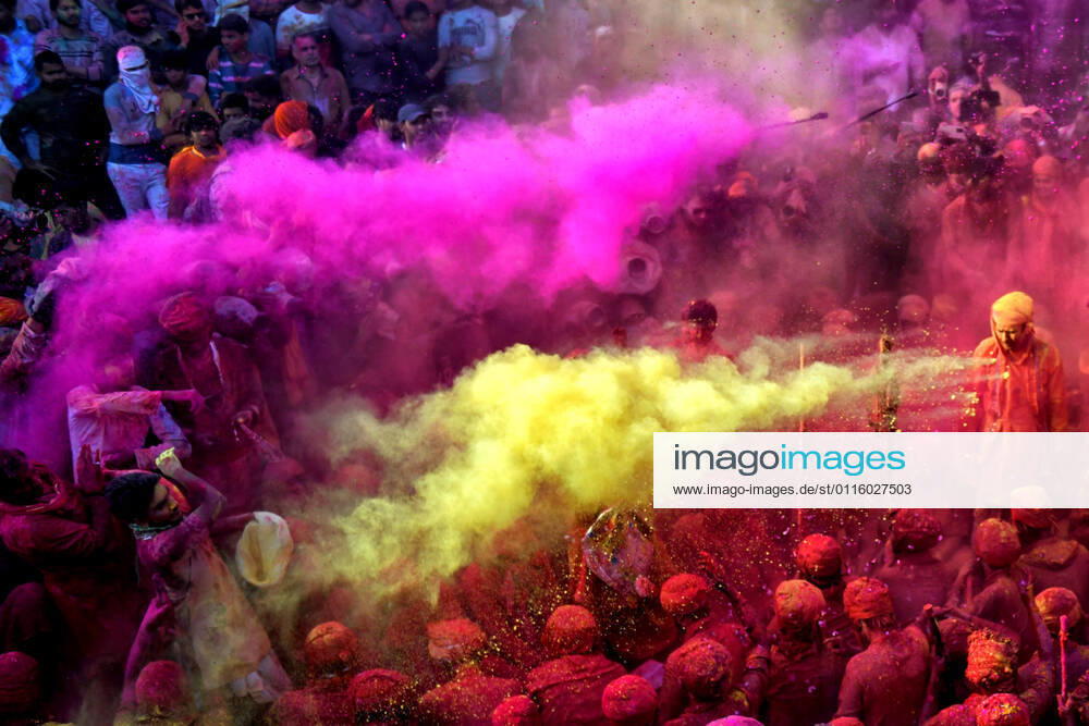 Hindu devotees play with colourful powders (Gulal) at Radharani Temple of Nandgaon in Mathura during the HOLI festival..Holi Festival of India is one of the biggest colourful celebration in India as many Tourists and devotees gather to observe this colourful event. Mathura India - ZUMAs197 20210324_zaa_s197_125