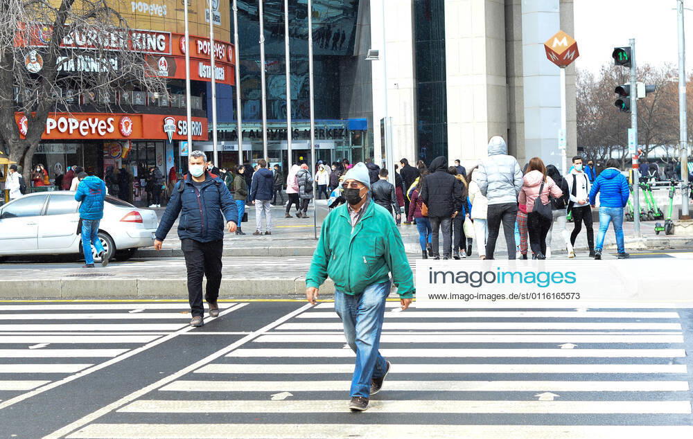People wearing face masks walk on a street in Ankara Turkey, on March 26, 2021. Turkey has confirmed 30,619 deaths and 3,120,013 positive cases of the coronavirus infection in the country. (