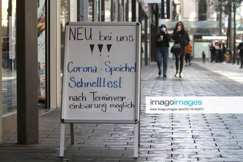 Stand with inscription new with us, Corona saliva quick test after appointment arrangement possibly stands before a pharmacy in the pedestrian precinct and shopping street Planken in the city center of Mannheim, Baden Wuerttemberg, Germany