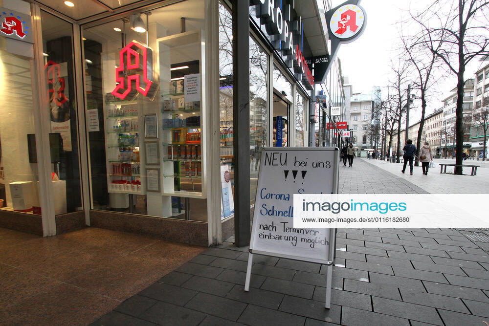 Stand with inscription new with us, Corona saliva quick test after appointment arrangement possibly stands before a pharmacy in the pedestrian precinct and shopping street Planken in the city center of Mannheim, Baden Wuerttemberg, Germany