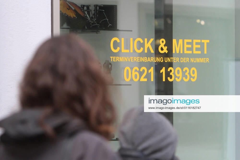 Lettering Click Meet book your personal shopping appointment is stuck in a shop window of a fashion store in the pedestrian zone and shopping street Planken in downtown Mannheim, Baden Württemberg, Germany