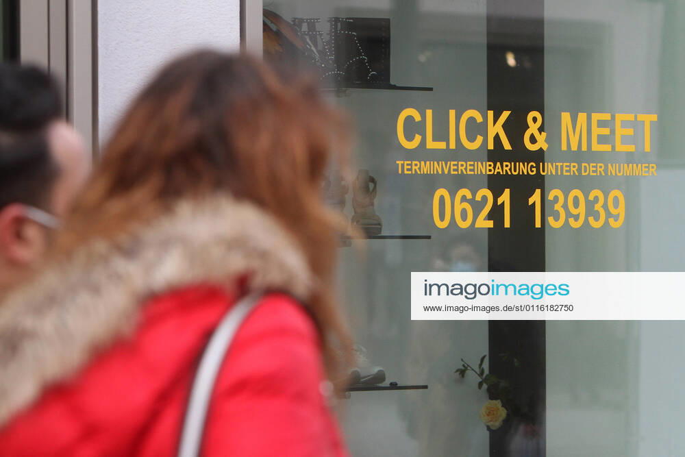 Lettering Click Meet book your personal shopping appointment is stuck in a shop window of a fashion store in the pedestrian zone and shopping street Planken in downtown Mannheim, Baden Württemberg, Germany