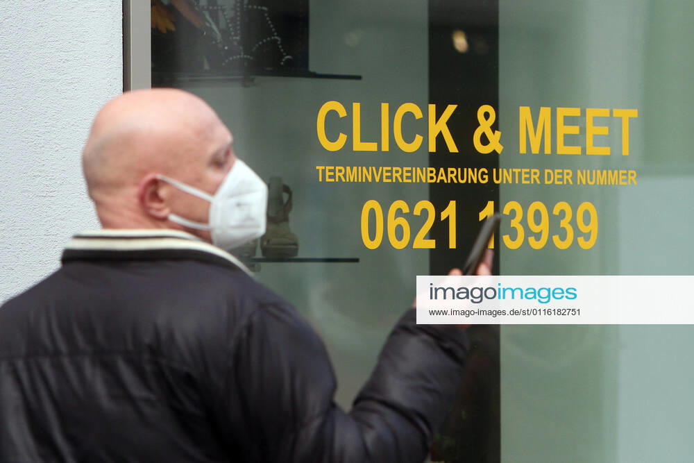 Lettering Click Meet book your personal shopping appointment is stuck in a shop window of a fashion store in the pedestrian zone and shopping street Planken in downtown Mannheim, Baden Württemberg, Germany