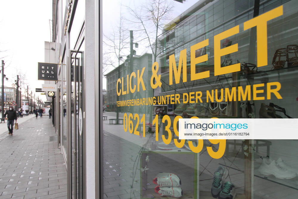 Lettering Click Meet book your personal shopping appointment is stuck in a shop window of a fashion store in the pedestrian zone and shopping street Planken in downtown Mannheim, Baden Württemberg, Germany