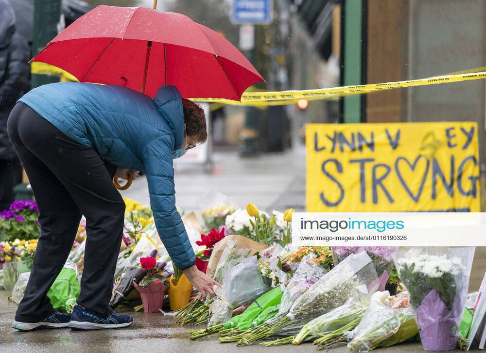 People lay flowers at a makeshift memorial outside of the Lynn Valley Library in Lynn Valley in North Vancouver, B.C., Sunday, March 28, 2021. A 28-year-old man was charged Sunday with second-degree murder in a stabbing rampage that left a young woman dead and injured six others in and around a library in North Vancouver, B.C., a day earlier. North Vancouver Canada - ZUMAc35_ 20210328_zaf_c35_110
