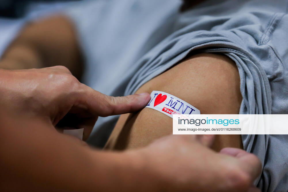 (210331) -- MANILA, March 31, 2021 -- A sticker is used as a sign on the arm of a resident after receiving a dose of Sinovac vaccine at a vaccination site in Manila, the Philippines on March 31, 2021. The Philippines Department of Health (DOH) reported on Wednesday 6,128 new COVID-19 infections, bringing the total number of confirmed cases in the Southeast Asian country to 747,288. ) PHILIPPINES-MANILA-COVID-19-SINOVAC VACCINES RouellexUmali