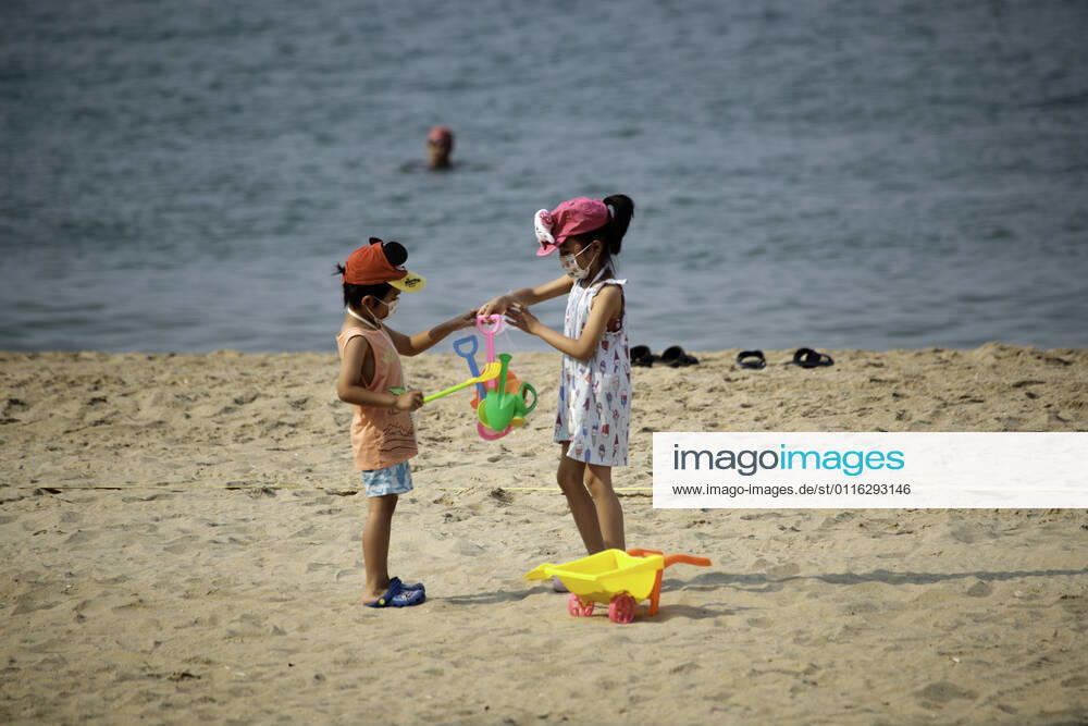 Beach reopen in Hong Kong under COVID-19 pandemic Hong Kong, China, Apr 02: Beach goers wear surgical mask play at the Gold Coast Beach in Hong Kong. Hong Kong China 6449_236305