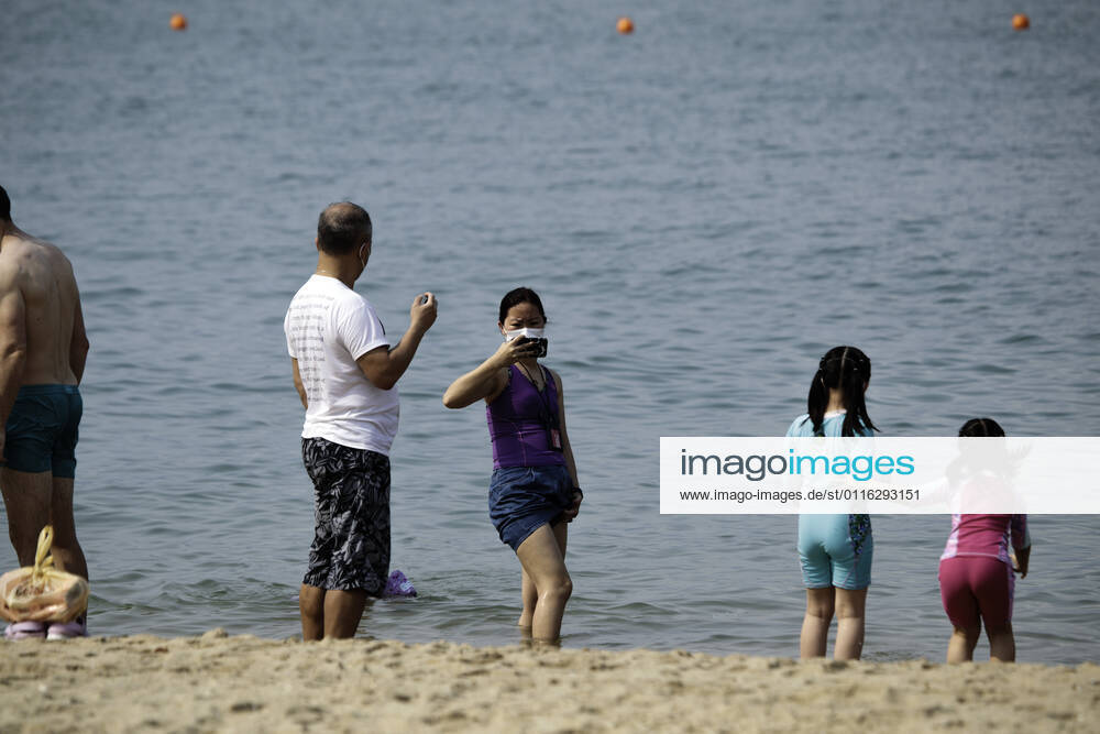 Beach reopen in Hong Kong under COVID-19 pandemic Hong Kong, China, Apr 02: Beach goers wear surgical mask play at the Gold Coast Beach in Hong Kong. Hong Kong China 6449_236310