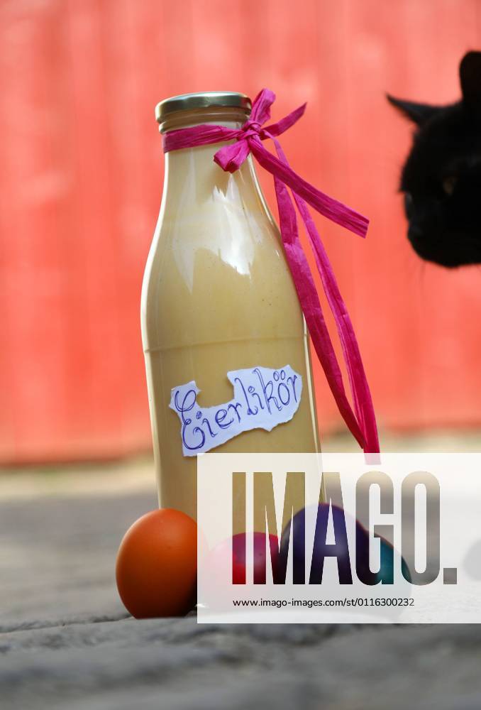 Eggnog 01 04 2021 , Ostramondra, homemade eggnog and colorful dyed eggs, a black cat comes curiously to it