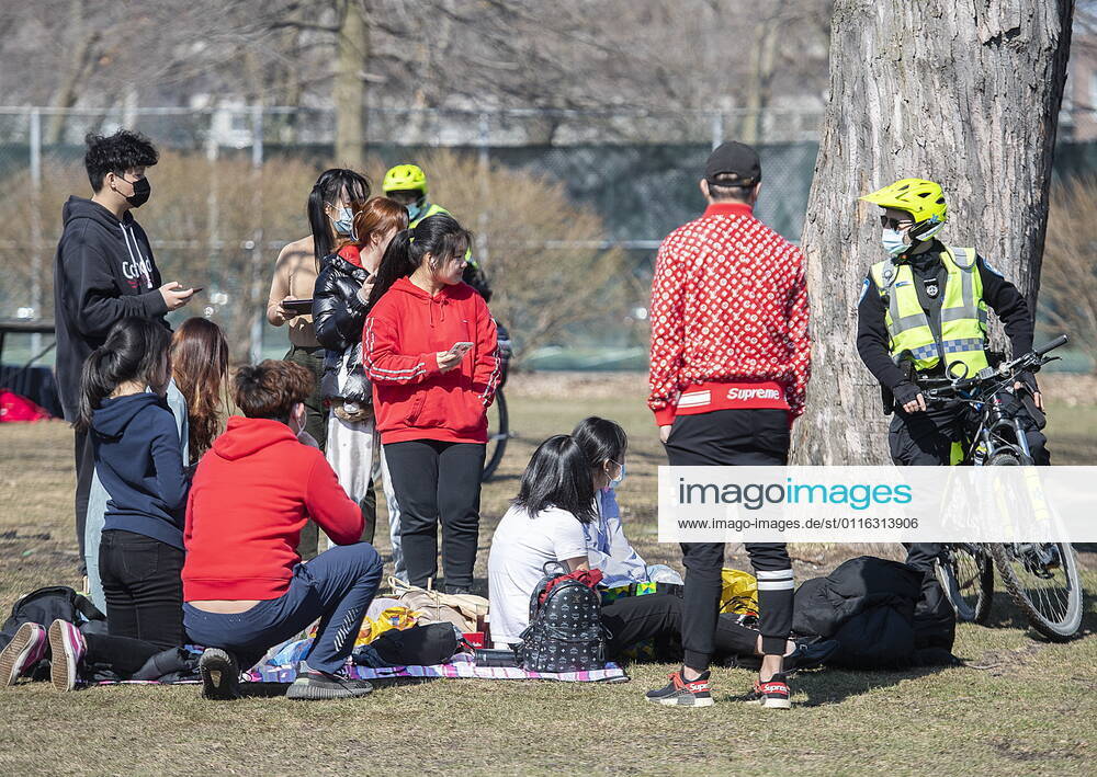 Police talk with people as they gather in a park in Montreal, Sunday, April 4, 2021, as the COVID-19 pandemic continues in Canada and around the world. Montreal Canada - ZUMAc35_ 20210404_zaf_c35_068