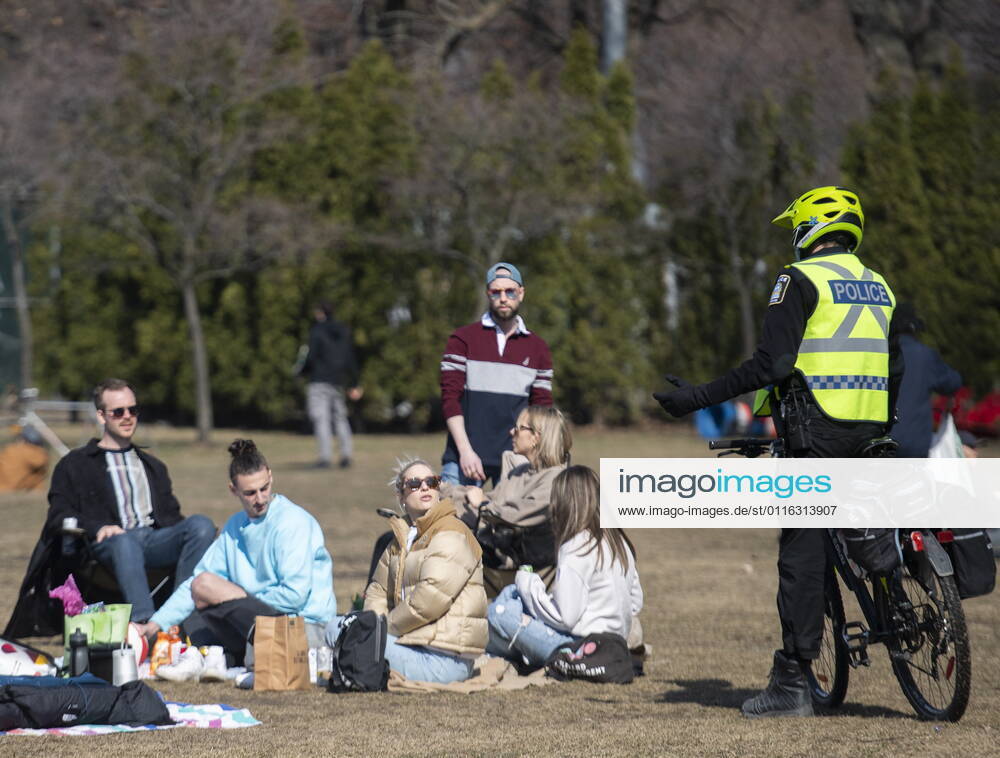 Police talk with people as they gather in a park in Montreal, Sunday, April 4, 2021, as the COVID-19 pandemic continues in Canada and around the world. Montreal Canada - ZUMAc35_ 20210404_zaf_c35_069