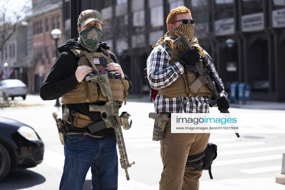 About a dozen self-described Boogaloo Bois stood with semi-automatic rifles outside the Ann Arbor City Hall and Police Department on April 4, 2021. They hope that Omar Saad Shafie, the subject of a 36-hour standoff with Washtenaw County SWAT on March 24, will be released, as they claim his Second Amendment rights were infringed. Shafie faces five felony charges after his parents called the police on him, claiming he assaulted them, was heavily armed, and was suffering a mental health crisis, according to a WSCO press release. The protest was held outside the Ann Arbor Police Department, even though Shafie was arrested by Washtenaw County Sheriffs. Ann Arbor USA - ZUMAs222 20210404_znp_s222_013