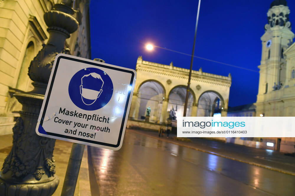 Theme image Is the bridge lockdown coming to break the third wave Deserted Odeonsplatz in Munich with Feldherrnhalle and Theatiner church Sign Maskenpflicht in den Fussgaengerzonen in Muenchen on 06 04 2021 Ausgangssperre,Ausgangsbeschraenkung,Nachtaufnahme,