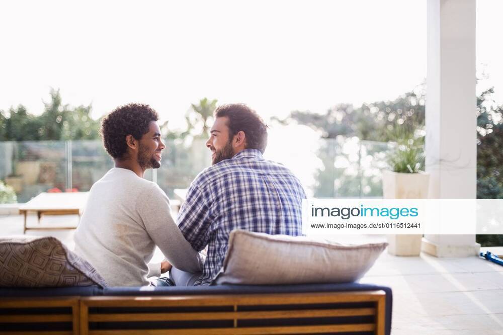 Happy couple sitting on sofa Happy couple sitting on sofa in terrace, model released, Cape Town, South Africa, 01.09.2015, 632879.jpg, home, lifestyle, leisure, domestic life, casual clothing, handsome, shirt, homosexual couple, gay man, homosexual, couple, relationship, together, love, affection, natural, happy, smiling, cheerful, couch, sofa, patio, garden, sunny, bright, spring, summer, weekend, free time, free, freedom, carefree, escapism 20s, Young Adult, Man, Male, Caucasian, Mixed-Race, 25-29 Years, Young Men, Caucasian Ethnicity, 20-24 Years, Mixed-Race Person Outdoors,Day