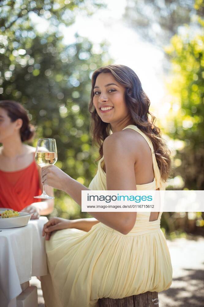 Woman holding a wine glass in restaurant Portrait of woman holding a wine glass in restaurant, model released, , property released, Cork, Ireland, 21.11.2016, 927384.jpg, restaurant, hotel, food and drink industry, retail, business, customer, hospitality, casual clothing, sitting, holding, glass, wine, smile, smiling, happy, drink, beverage, refreshment, beautiful, pretty, attractive, friend, friendship, together, leisure, lifestyle, millennial 20s, Young Adult, Woman, Female, Mixed-Race, 20-24 Years, Young Women, Mixed-Race Person