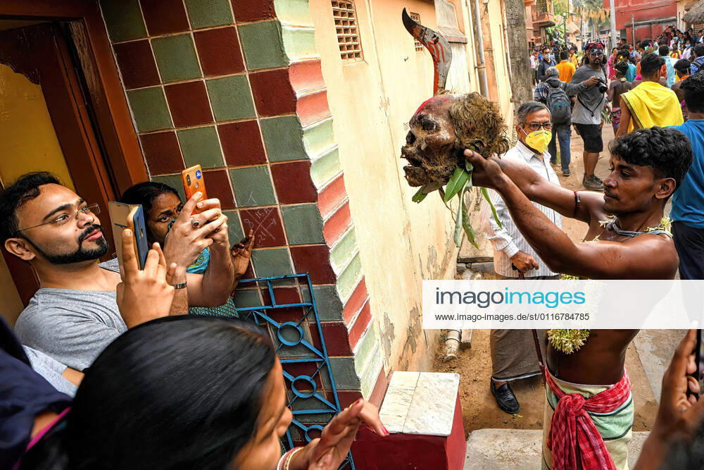 (EDITORS NOTE: Image depicts death) Hindu devotee seen showing a human skull and sword to the villagers during the Gajan Festival..The festival is related to Lord Shiva and as per Mythology on the last day of Bengali Calendar (Middle of April) devotees used to worship dead bodies to satisfy Lord Shiva for better rain and harvest as per 100 years old Traditional practices. The central theme of this festival is deriving satisfaction through non-sexual pain, devotion and sacrifice. Bardhaman India - ZUMAs197 20210413_zaa_s197_004