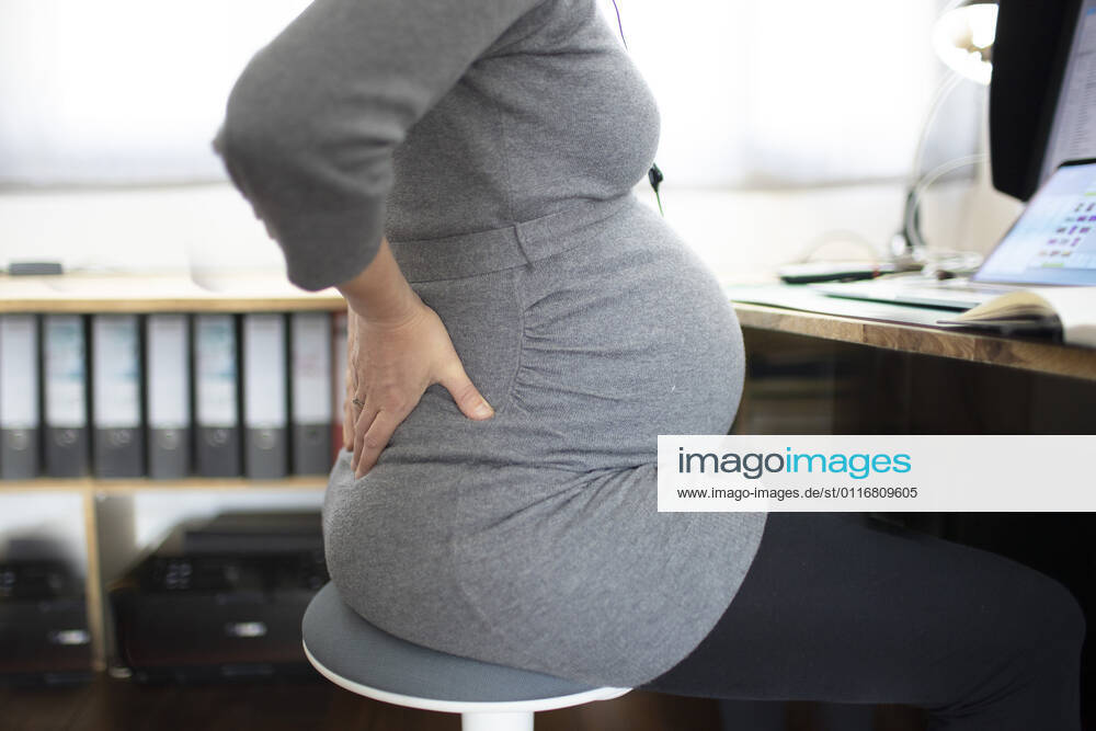 Young pregnant woman in pain at work Bonn Germany