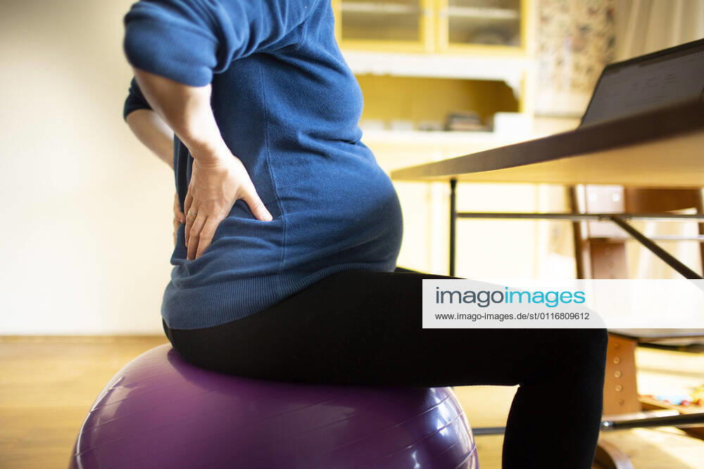 Young pregnant woman in pain at work Bonn Germany