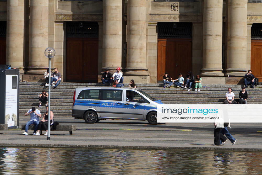 A police patrol of the state police Baden Württemberg controls the observance of the minimum distances at the Eckensee in front of the state theatre in the city centre of Stuttgart, Baden Württemberg, Bavaria, Germany