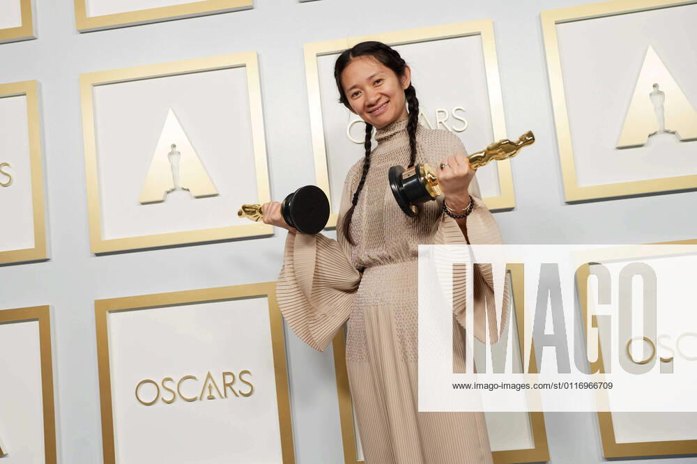 Chloe Zhao poses backstage with the Oscars for Directing and Best Picture the during the live ABC Telecast of The 93rd Oscars at Union Station in Los Angeles, CA on Sunday, April 25, 2021. Los Angeles CA USA