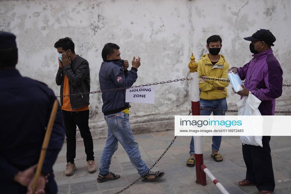 A man buys a face mask after Police detain them for not wearing the masks as the spread of coronavirus disease increases owing to the second wave of the virus in Kathmandu, Nepal on Tuesday, April 27, 2021. Kathmandu Nepal - ZUMAg200 20210427_zap_g200_002