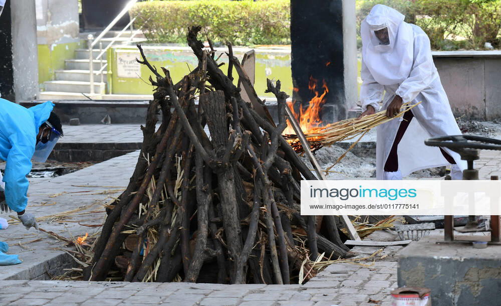 Cremation Of COVID-19 Victims In Rajasthan, India Family members, wearing protective suits, perform last rites before cremation of COVID-19 victim at Hindu Moksha Dham crematorium in Beawar. Beawar Rajasthan India