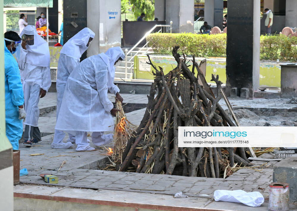 Cremation Of COVID-19 Victims In Rajasthan, India Family members, wearing protective suits, perform last rites before cremation of COVID-19 victim at Hindu Moksha Dham crematorium in Beawar. Beawar Rajasthan India