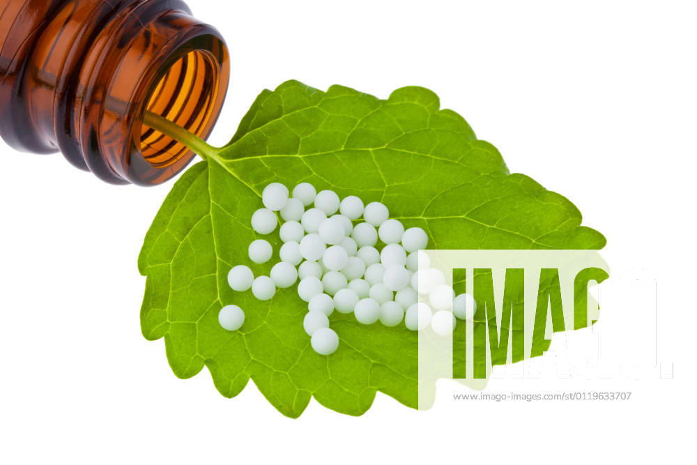 Homeopathy globules as alternative medicine lying on a sheet McPBBO McPBBO